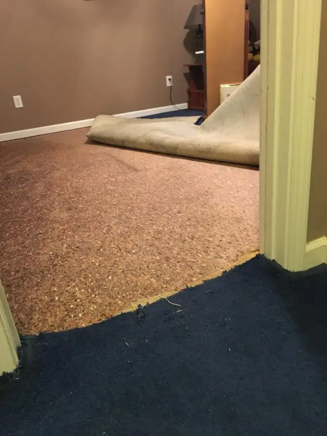 Carpet pad removal revealing water damage during Water Mitigation Services in Key Largo